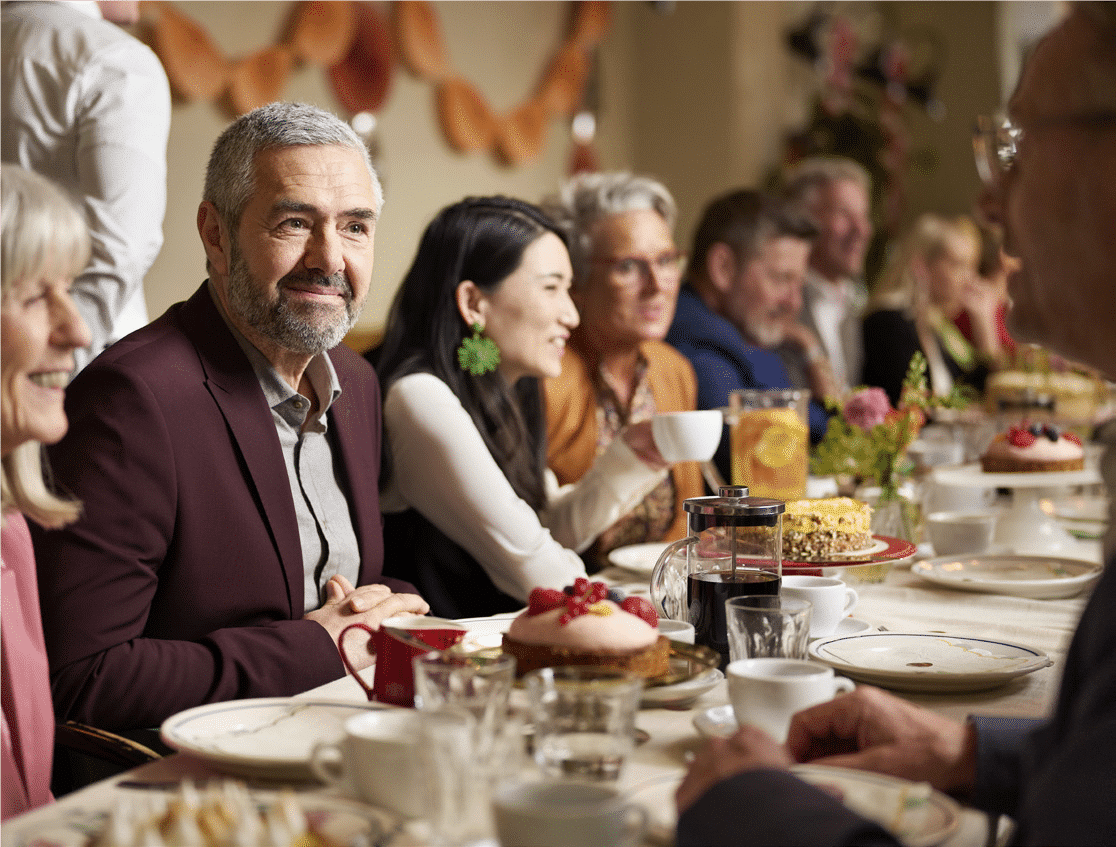 a group of people eat dinner together at a table