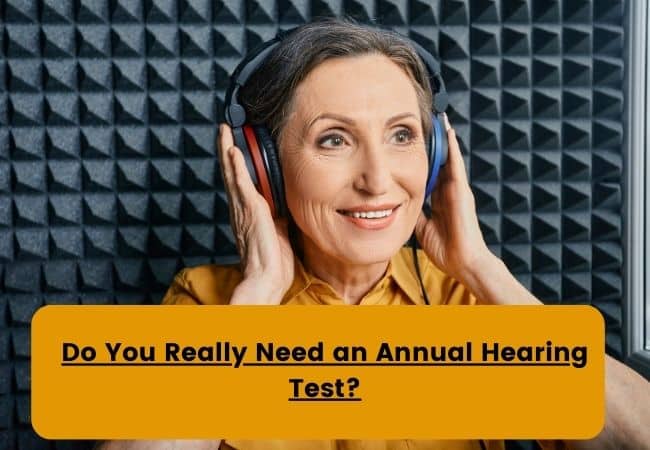 A woman takes a hearing test in a sound booth