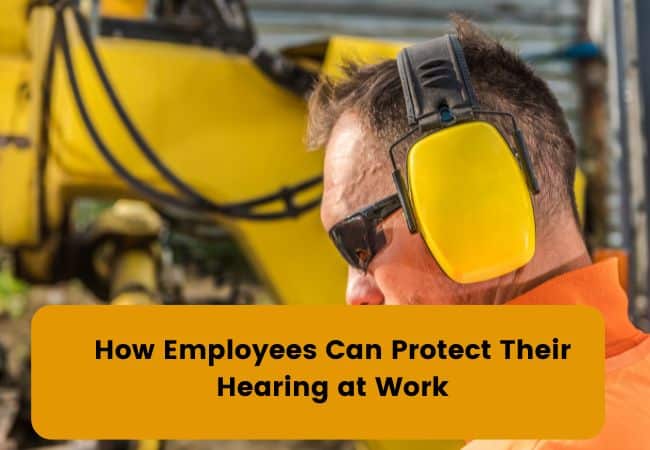 A man wears hearing protection on a construction site.