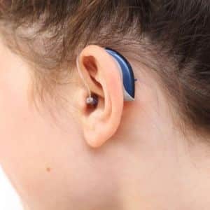 blue hearing aid on girl