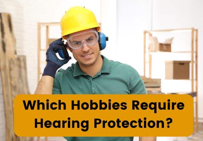 A man wears hearing protection in a garage.