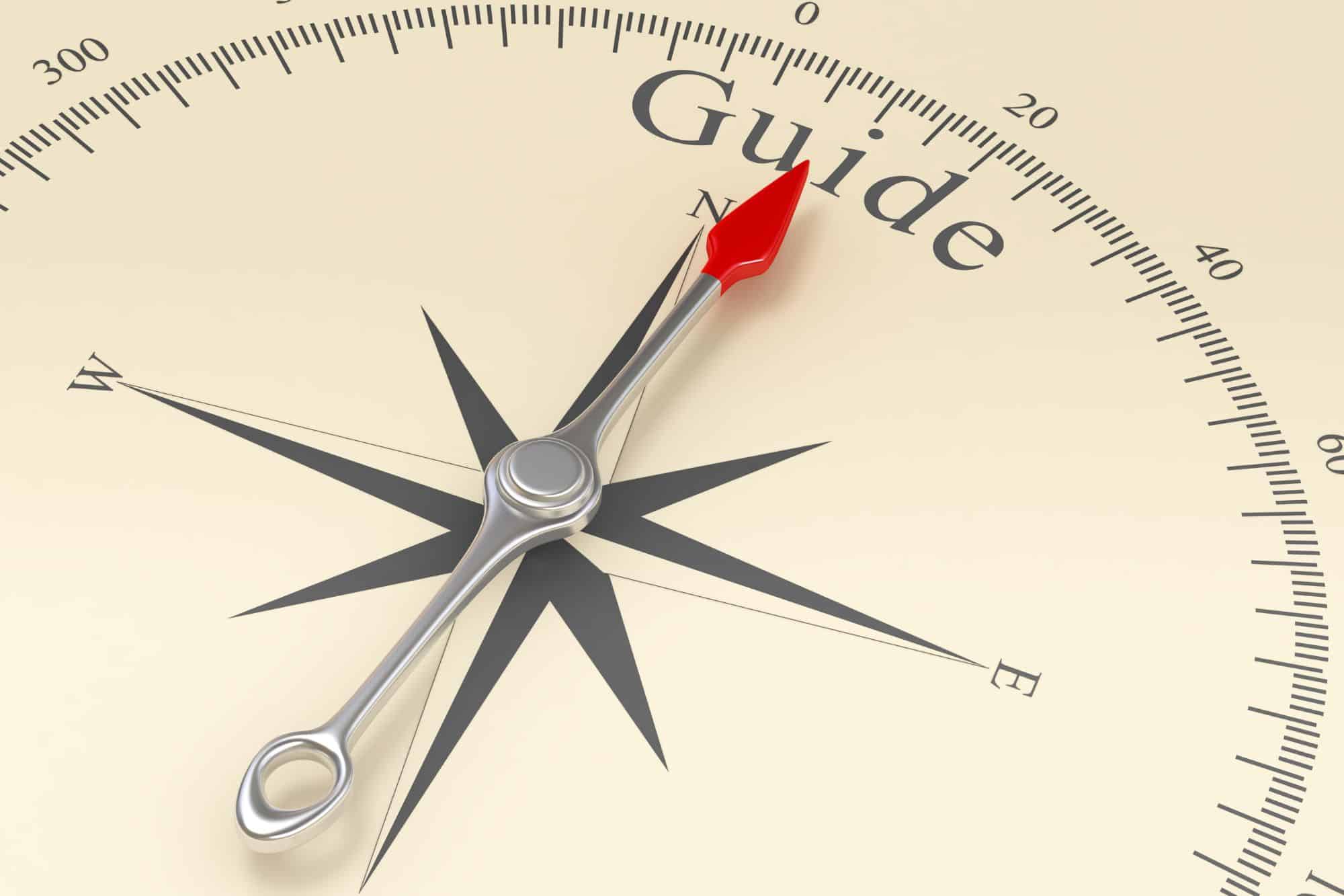 compass with the needle pointing to guide