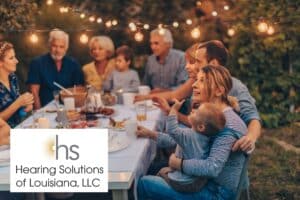 family sitting at a picnic table having dinner