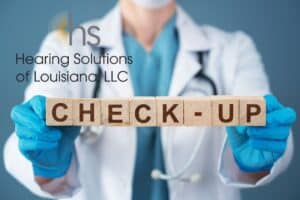 doctor holding wooden blocks that say check-up