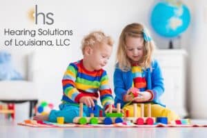 two small children playing with colorful blocks