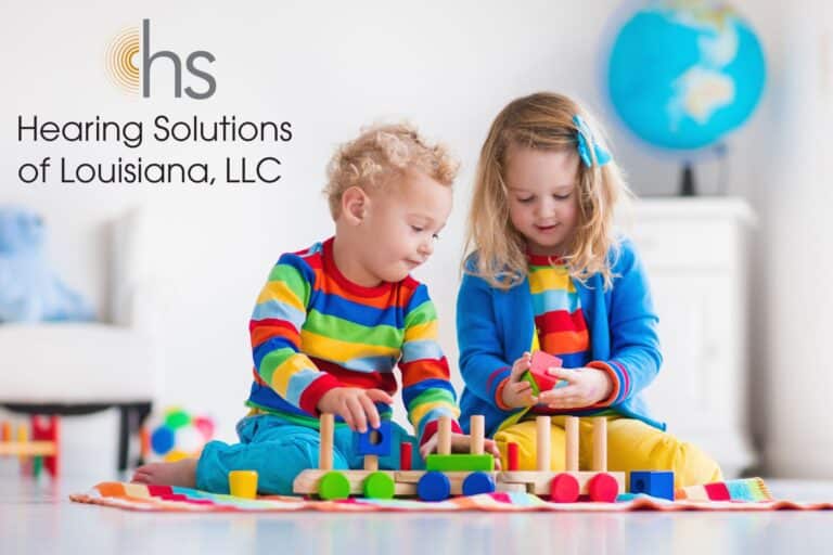 two small children playing with colorful blocks