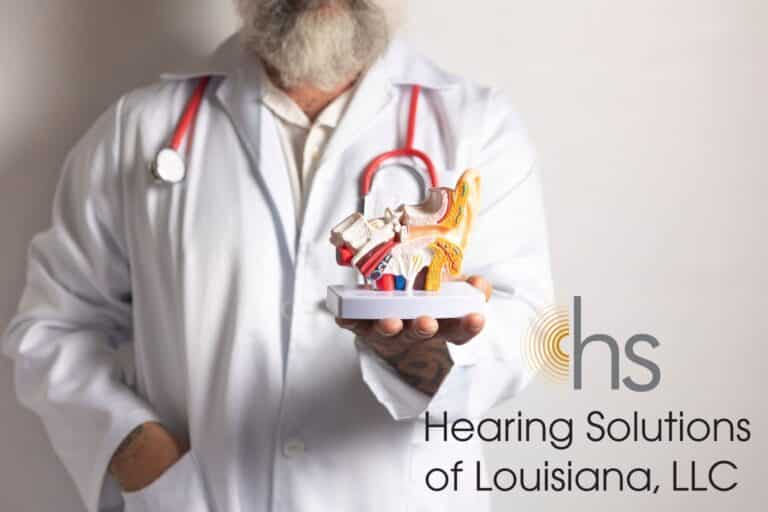 doctor holding a model of an ear