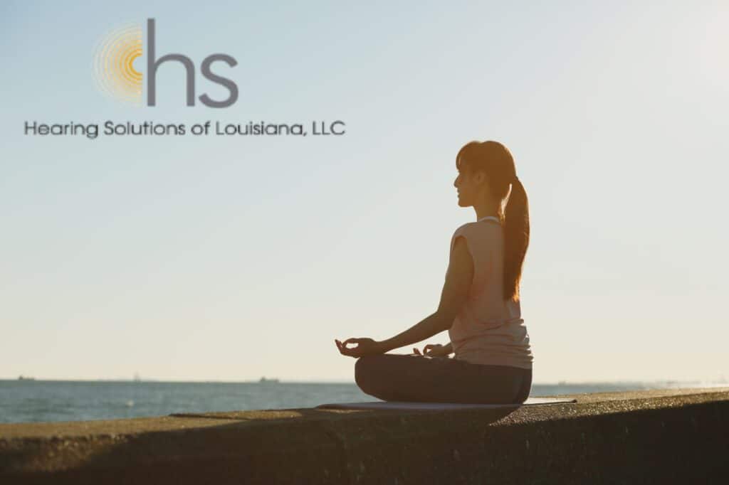 woman doing yoga by the ocean