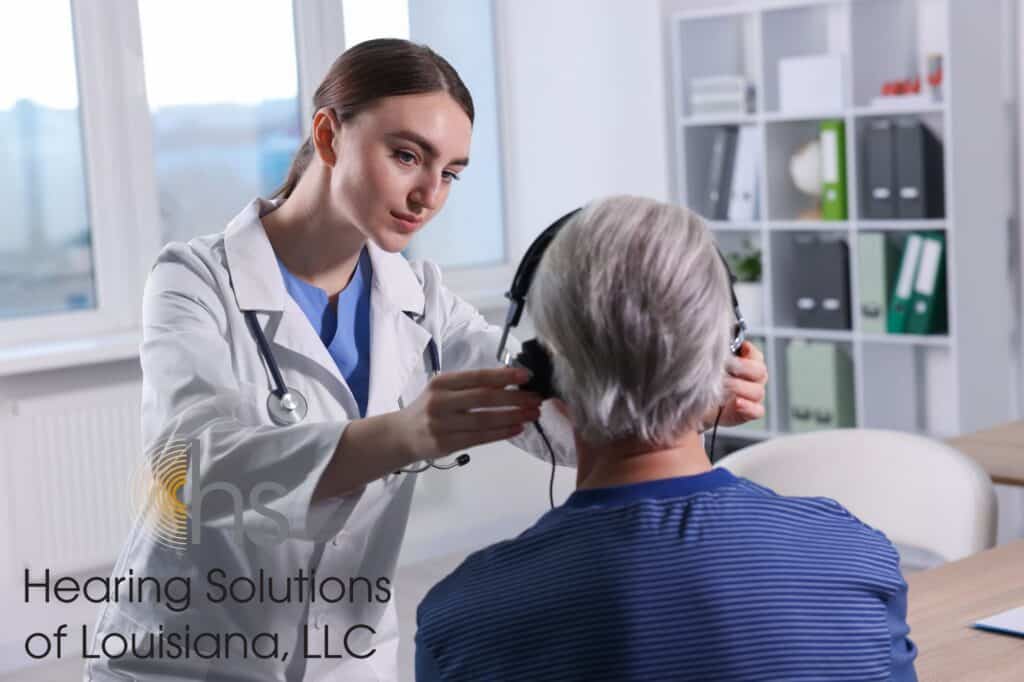 audiologist administering a hearing test to a woman